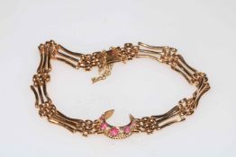 Gold gate bracelet with crescent of rubies and diamonds, 18cm length.