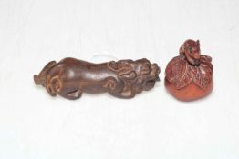 Two Japanese hardwood netsuke, lion 9.5cm length.