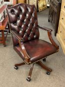 Ox blood buttoned leather swivel desk chair.