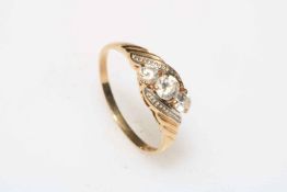 9 carat gold three white stone crossover ring, size T.