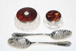 Two silver and tortoiseshell lidded toilet jars, and pair of EP berry spoons.