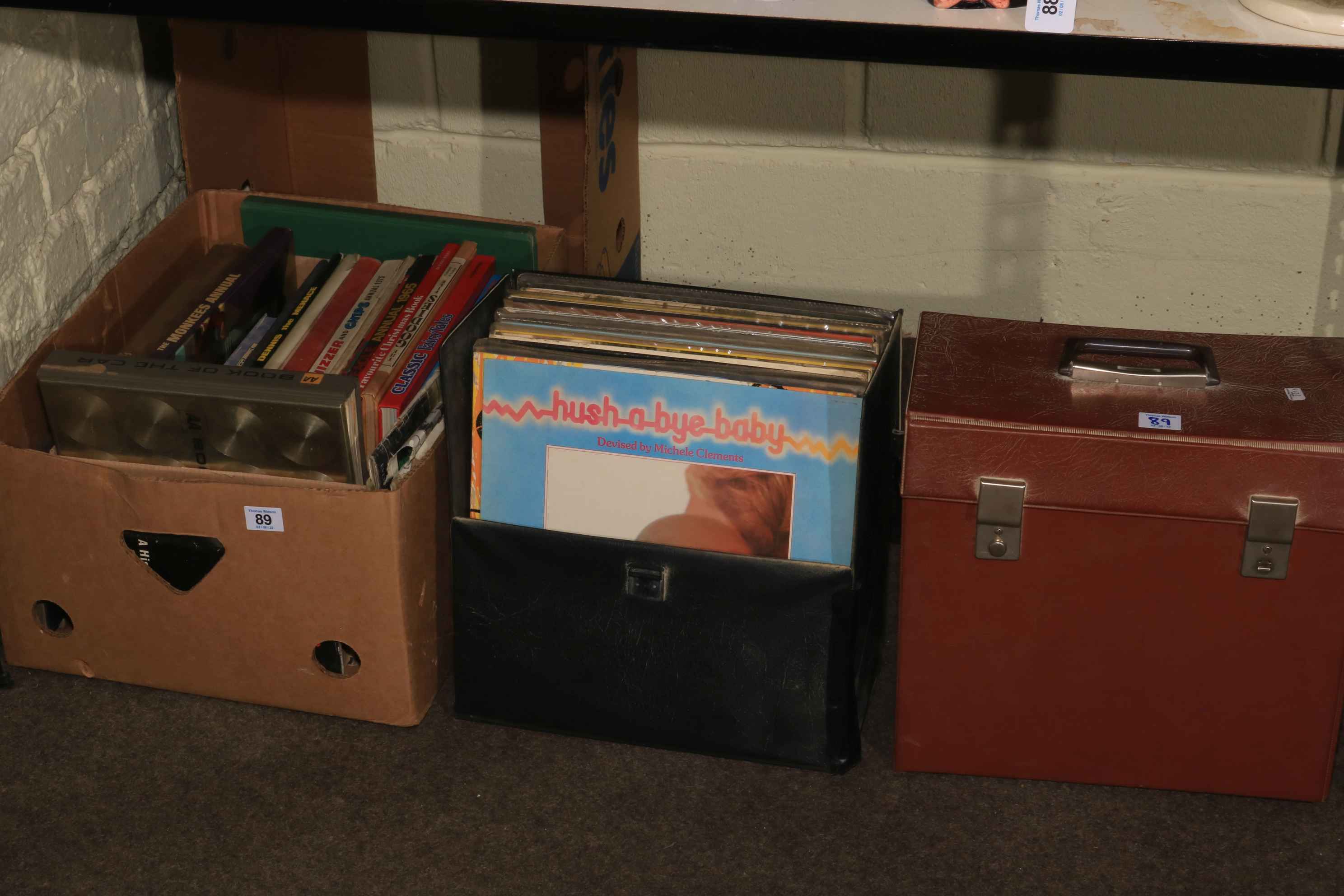 Two cases of LP records and box of books.