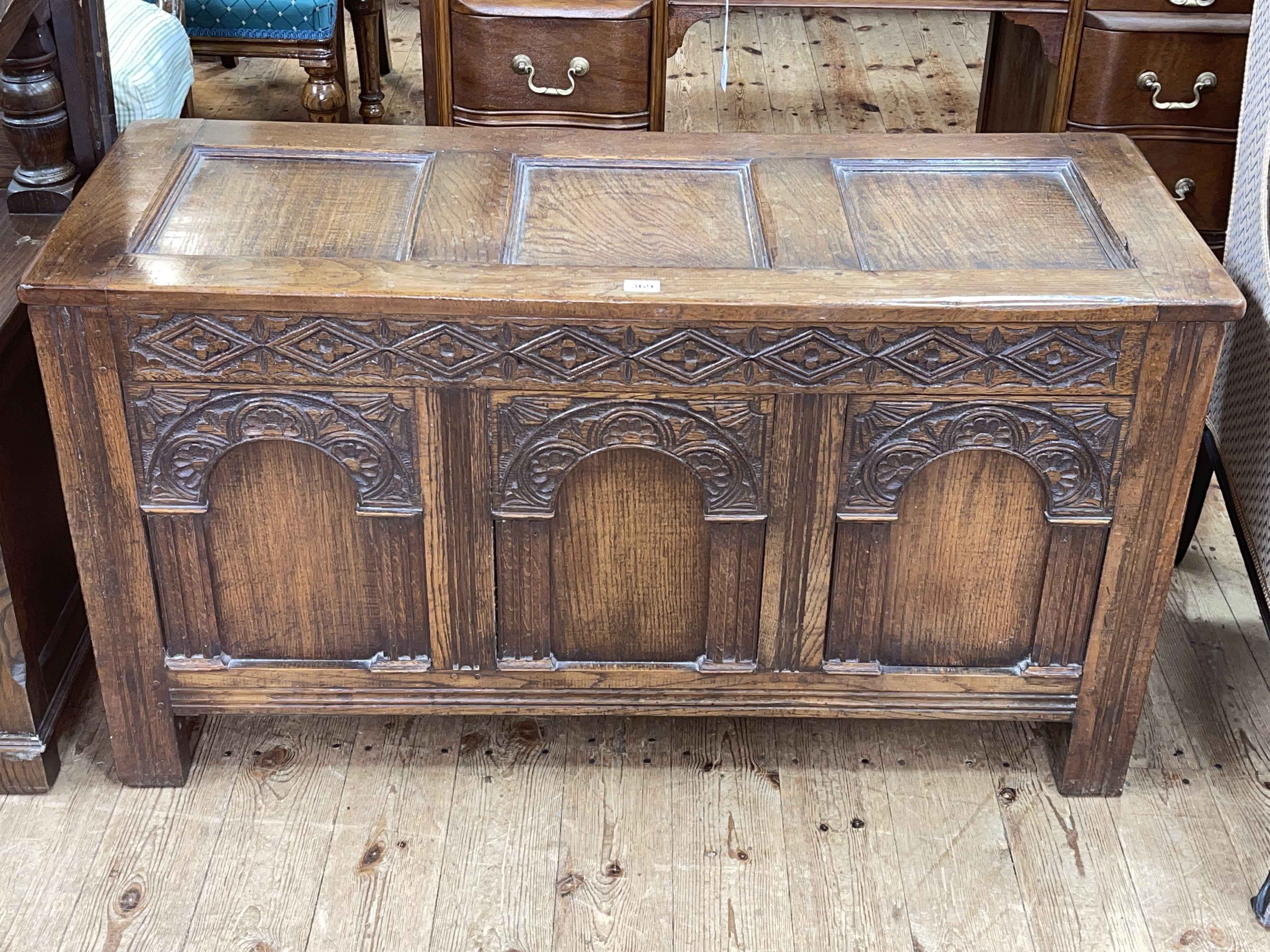 Carved oak triple panel front coffer, 58cm by 107cm by 42cm.