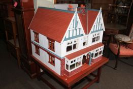 Large Elizabethan style dolls house with electrics on portable stand.