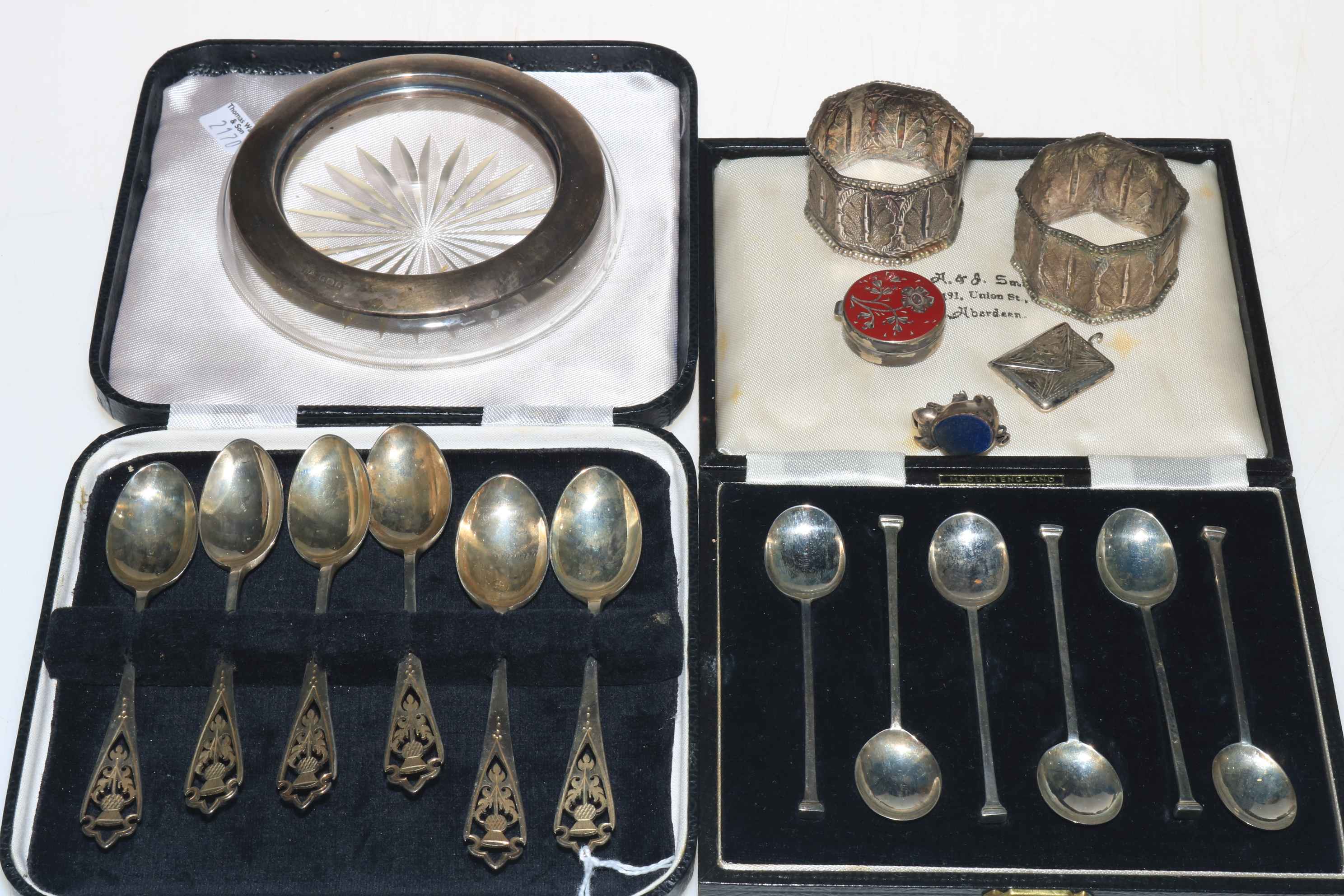 Two cased sets of silver teaspoons and coffee spoons, silver stamp holder and small box,