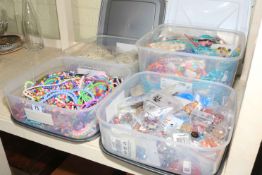 Four boxes of beads and jewellery.