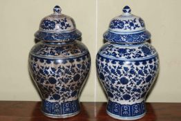 Pair Chinese blue and white baluster vases and covers, 30cm.