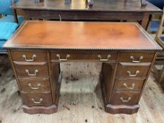 Hardwood nine drawer pedestal desk with leather inset top, 74cm by 112cm by 54cm.