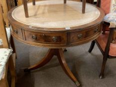 Mahogany and line inlaid four drawer drum table with leather inset top, 75cm by 91cm diameter.