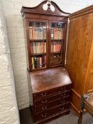 Shaw of London mahogany bureau bookcase and collection of books, 208cm by 77cm by 47cm.