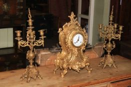 An ornate gilt metal three piece clock garniture.