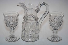 Heavy cut glass jug and two goblets.