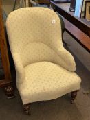 Late Victorian occasional armchair raised on turned legs.