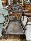 Pair Victorian carved oak armchairs with studded hide seats.
