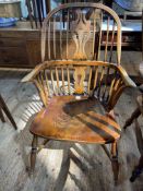19th Century elm Windsor chair raised on turned legs with crinoline stretcher.