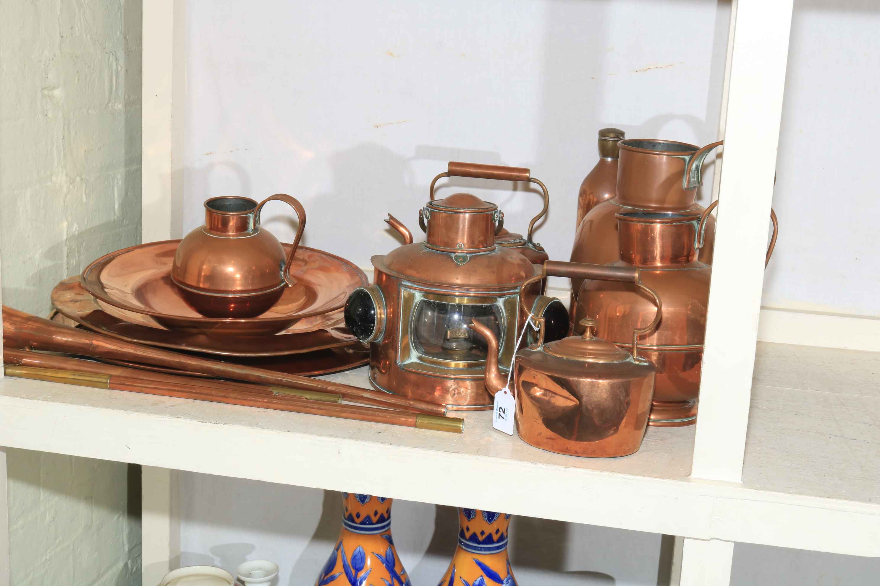 Collection of copper wares including ships lamp, hunting horns, three graduated jugs,