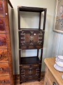 Oriental style brass mounted slim cabinet having four cupboard doors,