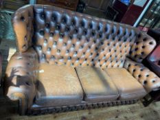 Brown leather studded back wing Chesterfield settee.