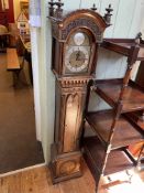 Ornate mahogany cased Westminster chime grandmother clock with brass and silvered dial.