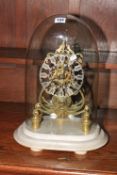 Brass skeleton clock under glass dome, 44cm high.