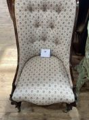 Victorian rosewood nursing chair with button back floral upholstery.