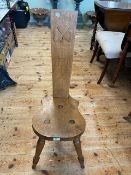 Oak three legged sewing chair, the back having a carved shamrock motif.