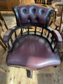 Mahogany and leather swivel desk chair.