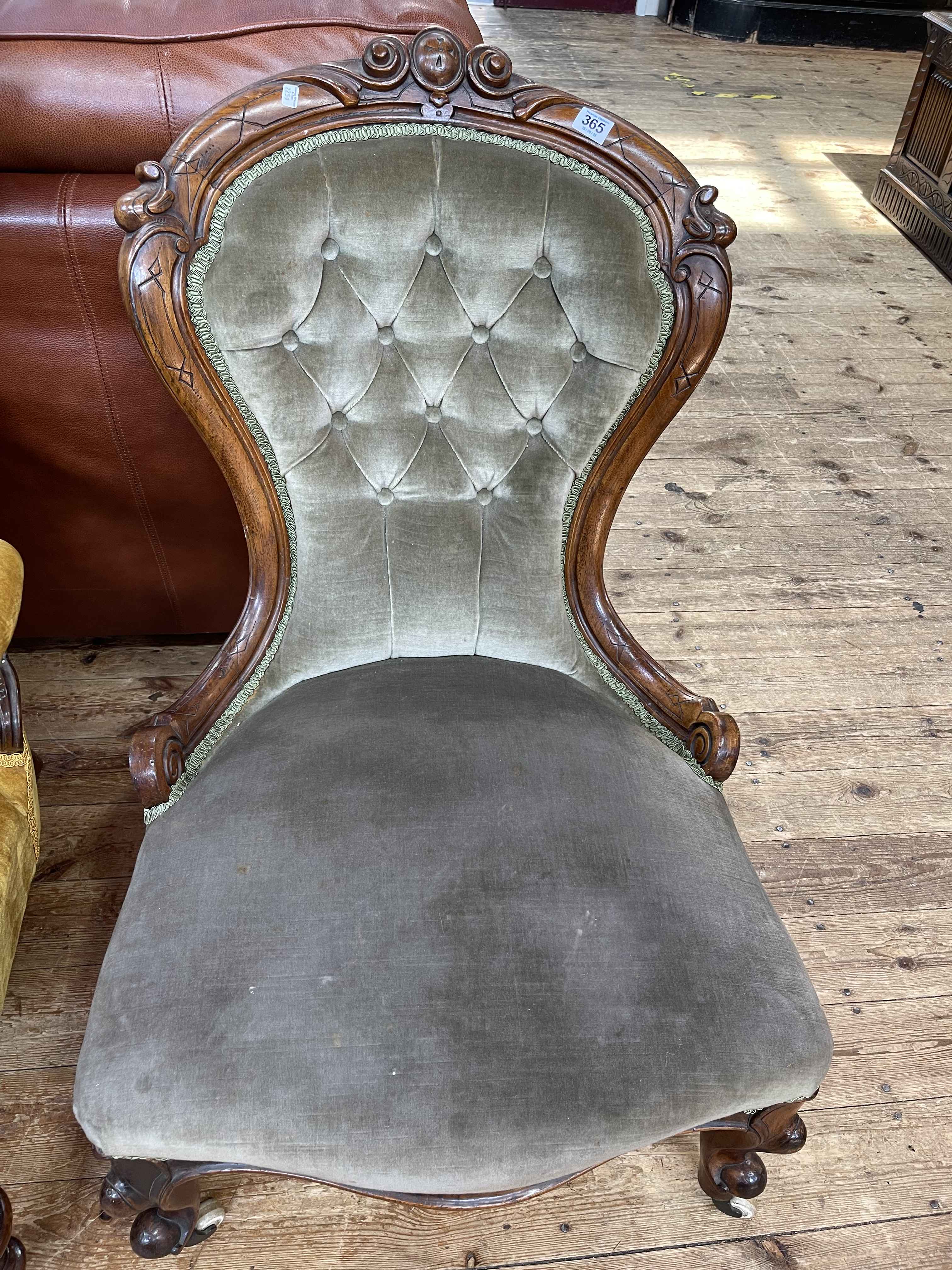 Victorian walnut framed nursing chair upholstered in green buttoned draylon.