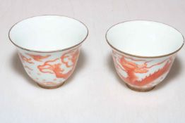 Pair Chinese iron red dragon tea bowls.