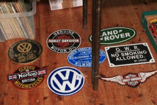 Eight assorted motoring signs including Harley Davidson, Norton, Land Rover, etc.