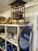 Bamboo occasional table with integrated magazine rack and oval gilt framed wall mirror.