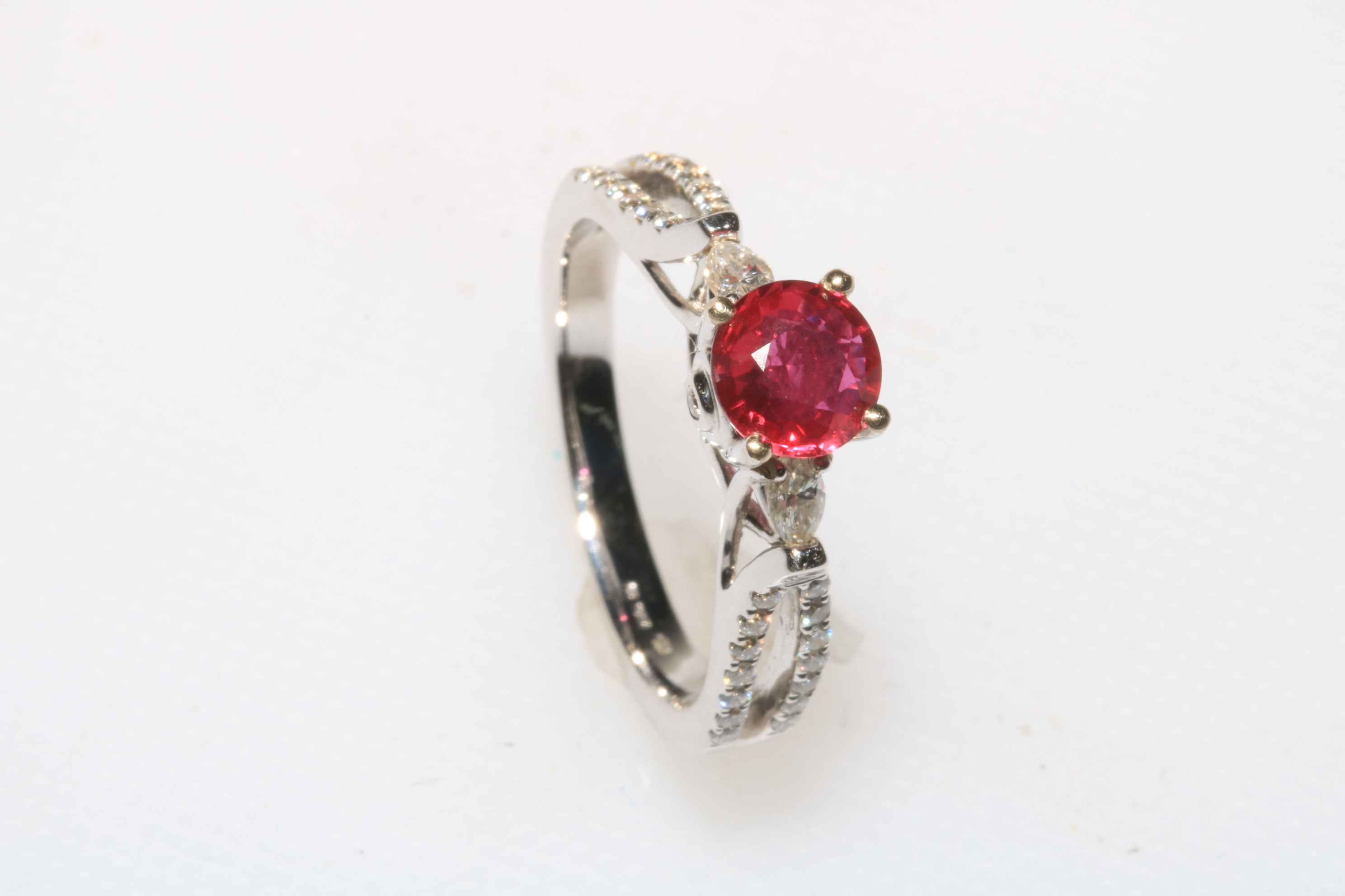18 carat white gold, oval ruby and diamond ring, ruby 0.86 carat, total diamond weight 0.