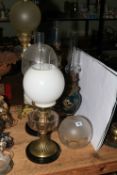 Five Victorian oil lamps including hand painted porcelain, brass ornate columns,
