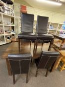 Rectangular dining table and six chocolate brown dining chairs.