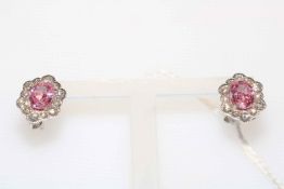 Pair of pink sapphire and diamond petal design cluster earrings set in white gold.