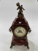 Victorian slate and brass mounted mantel clock with cherub mounted top, 46cm high.