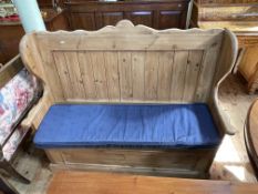 Pine wing back box settle with seat cushion, 113cm by 127cm by 46cm.