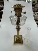 Victorian brass columned oil lamp with glass reservoir, 71cm high.
