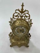 Ornate gilt metal mantel clock with cherub face column named 'Lambert Levy', 38cm high.