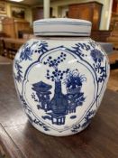 Large Chinese blue and white lidded ginger jar decorated with panels and flowers, 26cm high.
