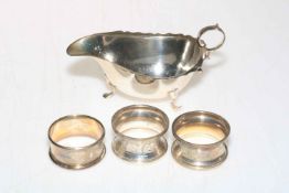 Silver sauce boat, Birmingham 1924, and three silver napkin rings (4).