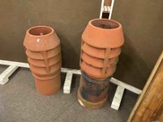 Two terracotta aerated chimney pots.