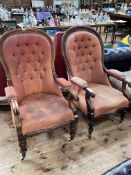 Two similar Victorian mahogany framed open armchairs in buttoned fabric.