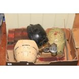 Box of vintage mining books, helmets and lamps.