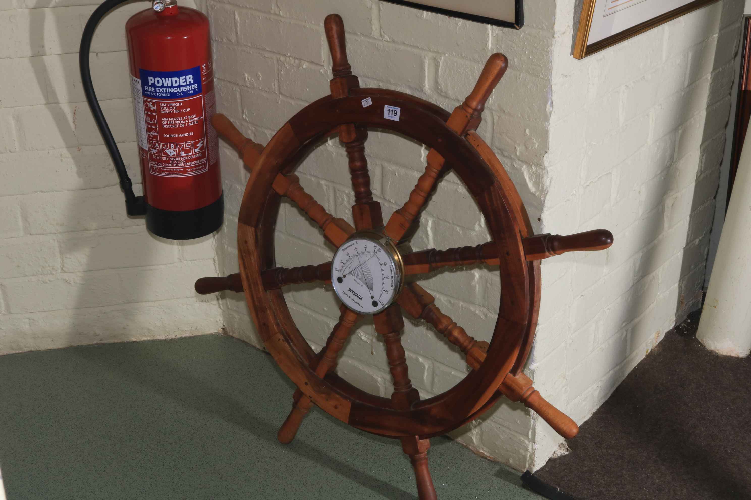 Eight spoke ships wheel with Wymark thermometer.