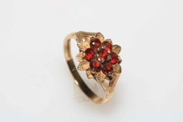 Garnet seven stone 9 carat gold ring, size S.