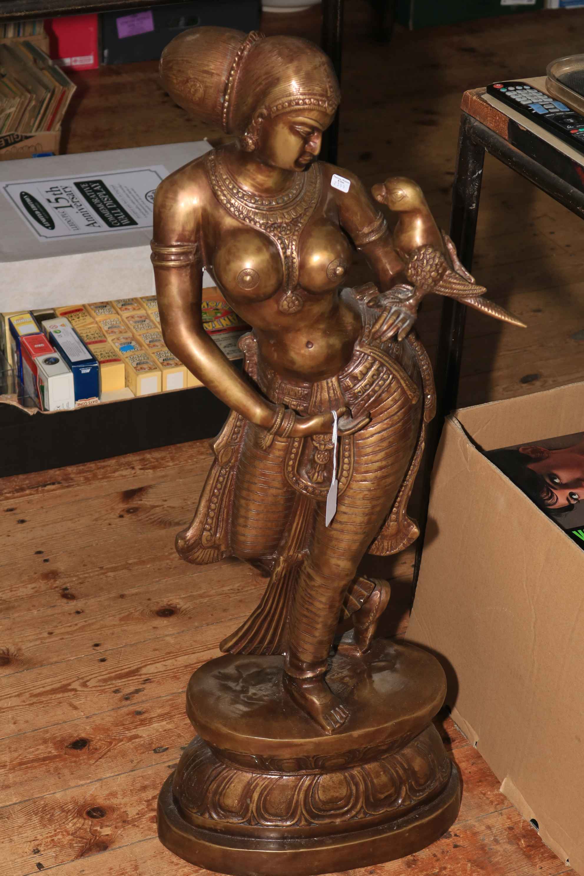Large bronze semi-clad Balinese figure holding bird, 92cm.
