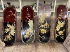 Set of four Oriental lacquered panels with applied bird and floral decoration.