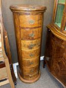 Cylindrical hardwood seven drawer chest, 120cm by 45cm diameter.