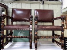 Pair studded hide elbow chairs on bobbin legs.